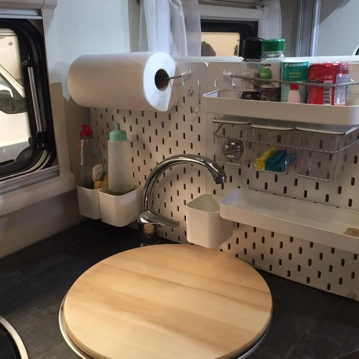 Install a Pegboard Behind the Sink So Bins Can Move Wherever You Need Them